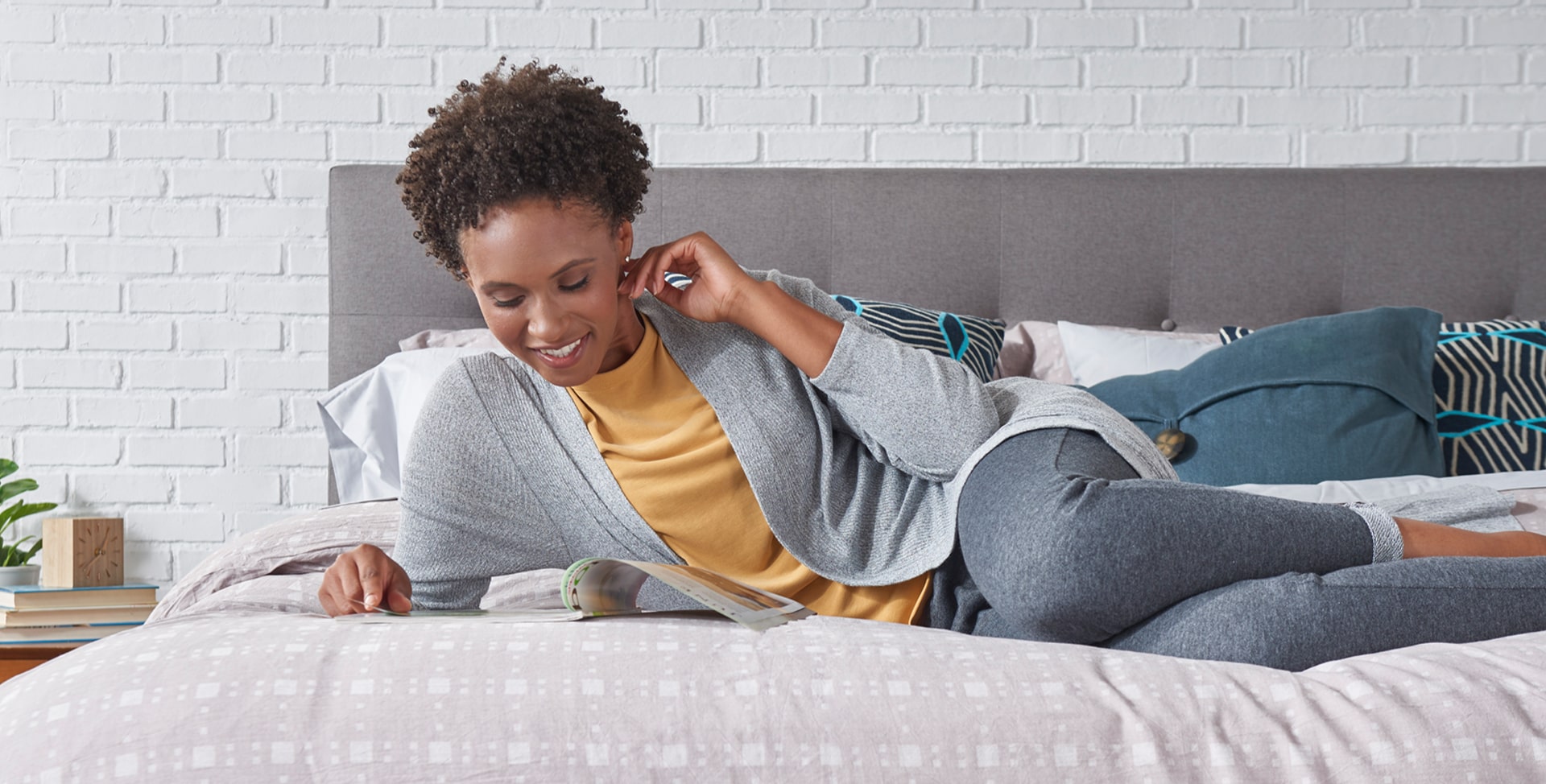 Woman with tablet on Cj® mattress